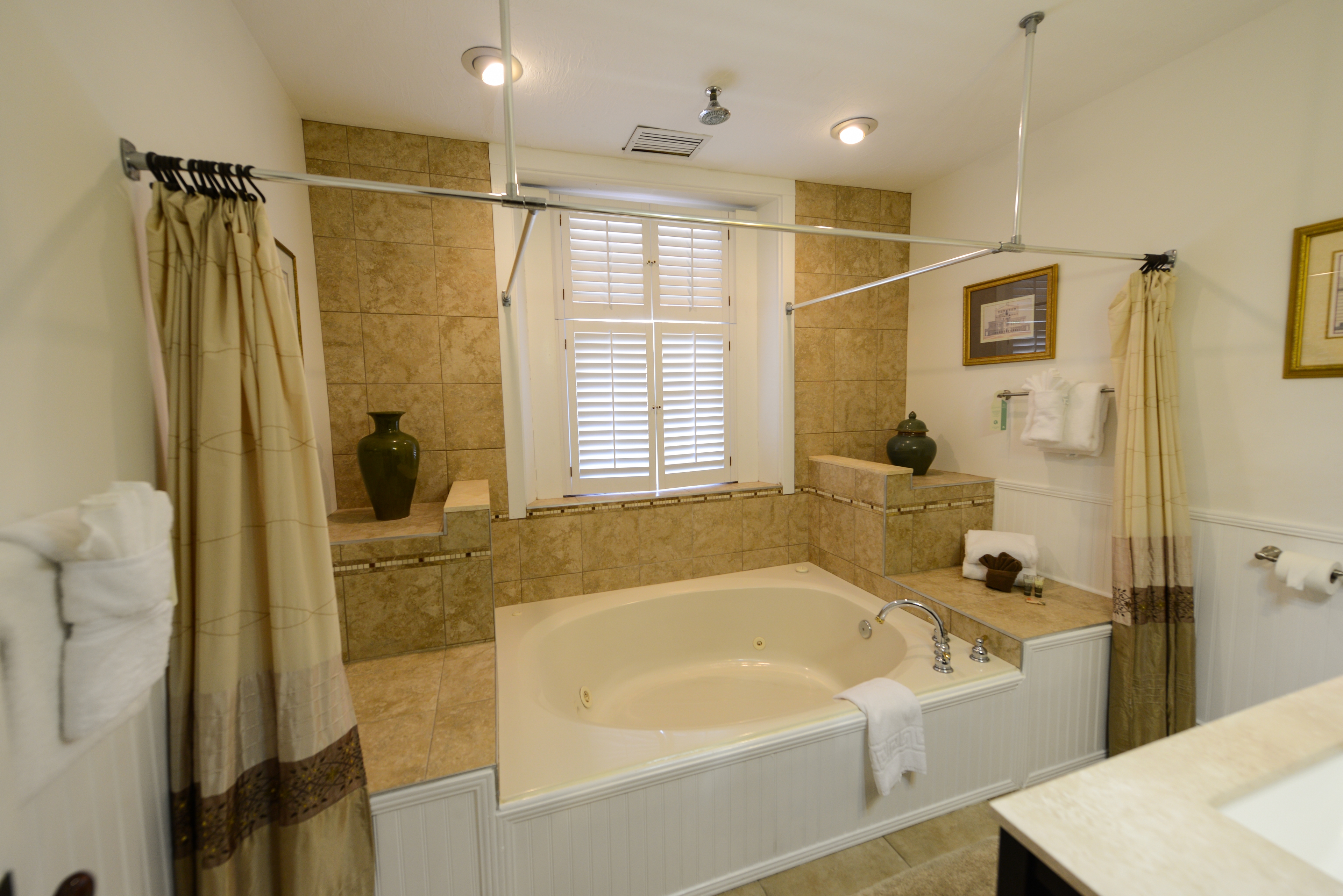 Spacious bathroom with two-person whirlpool garden tub and sink with vanity