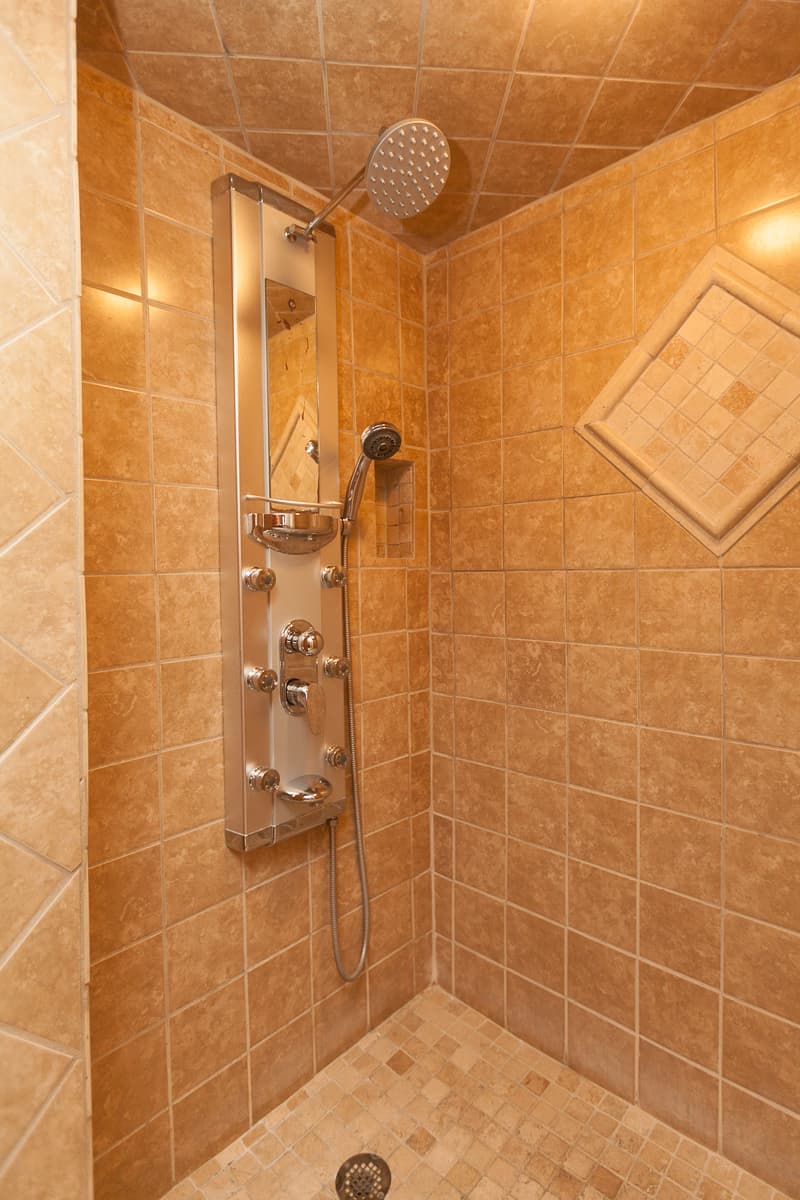 Gorgeous tiled walk-in shower with massage system.