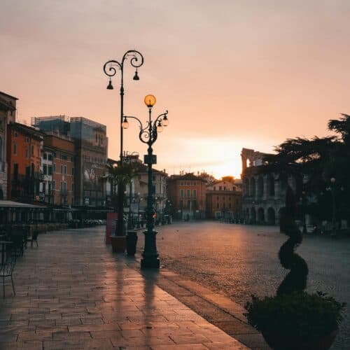 A quiet street at sunset, lined with colorful buildings and streetlamps. A quiet street at sunset, lined with colorful buildings and streetlamps.